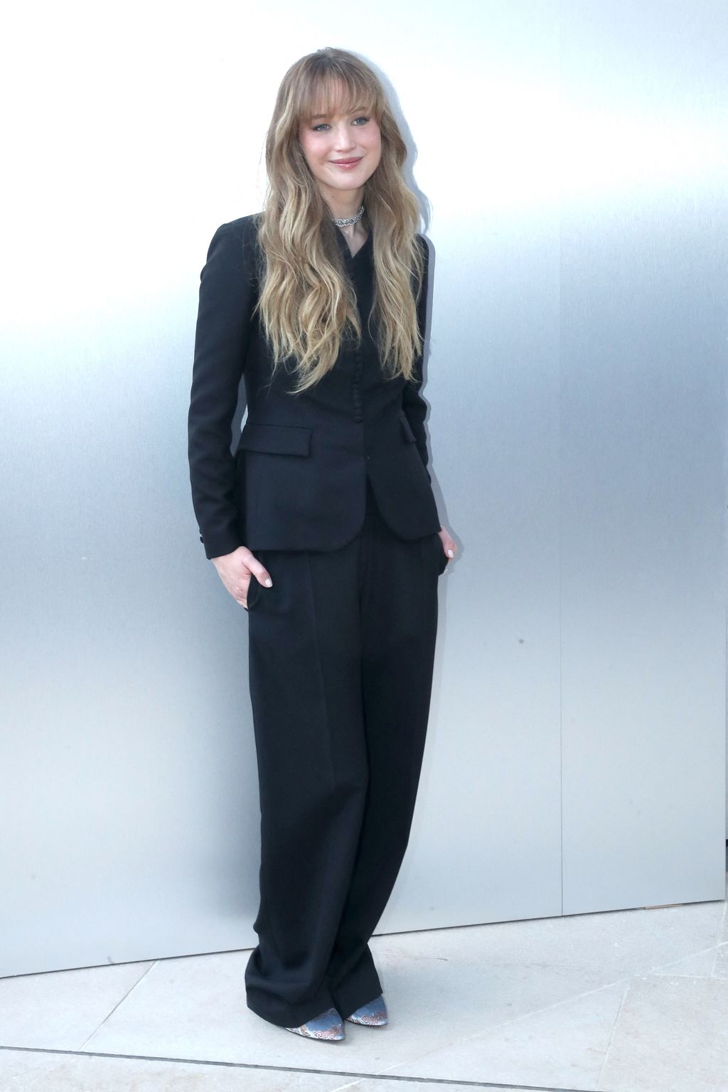 Image may contain Jennifer Lawrence Clothing Formal Wear Suit Blazer Coat Jacket Adult Person Standing and Blonde