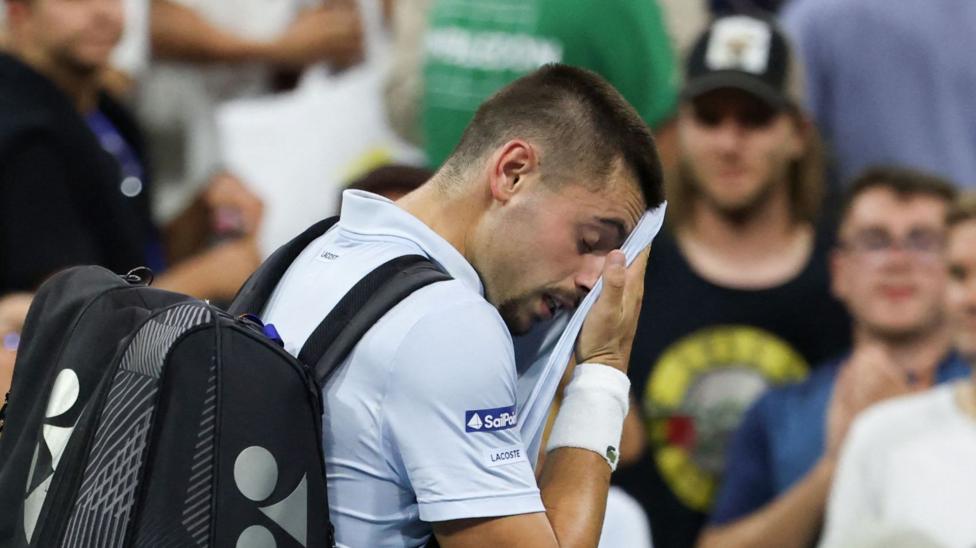 Arthur Gea wipes his face as he walks off court at the US Open