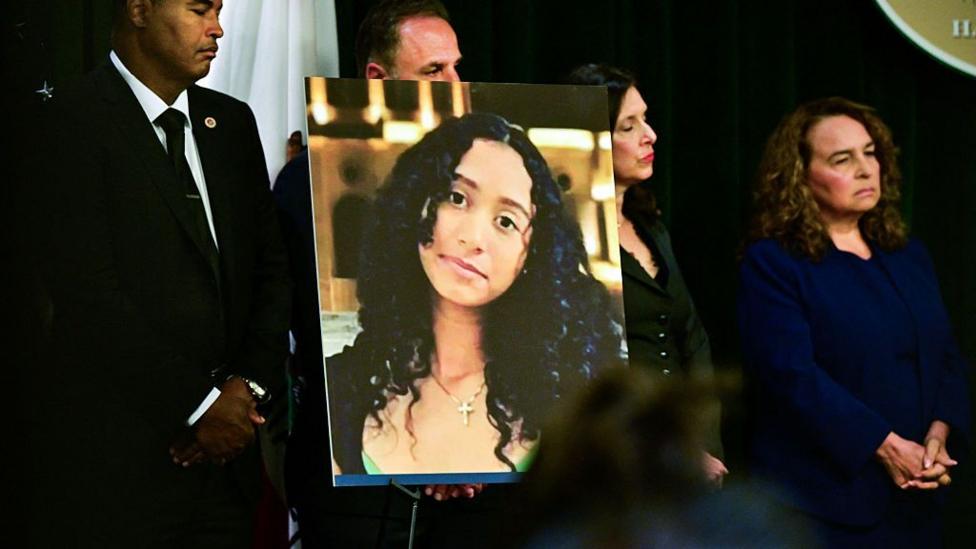 A portrait of the late Celeste Rivas Hernandez is shown during a press briefing by Los Angeles County District Attorney Nathan J Hochman (out of frame) on 20 April 2026.