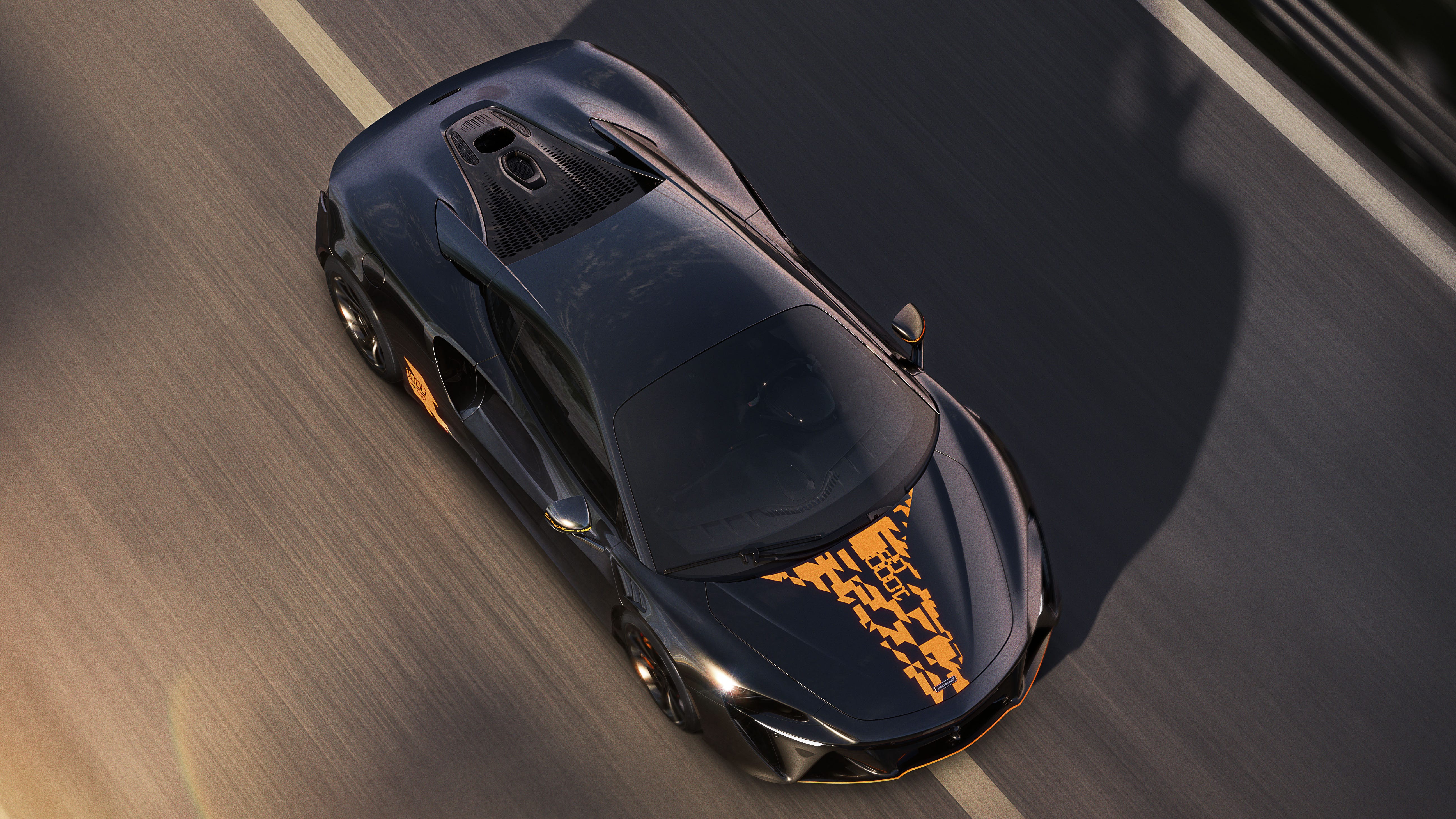 top view, sports coupe driving on track with graphic hood decal and motion blur.